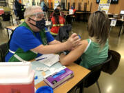 Jack Stump administering a vaccine during a Clark County Public Health vaccination clinic at Woodland High School in March 2021.