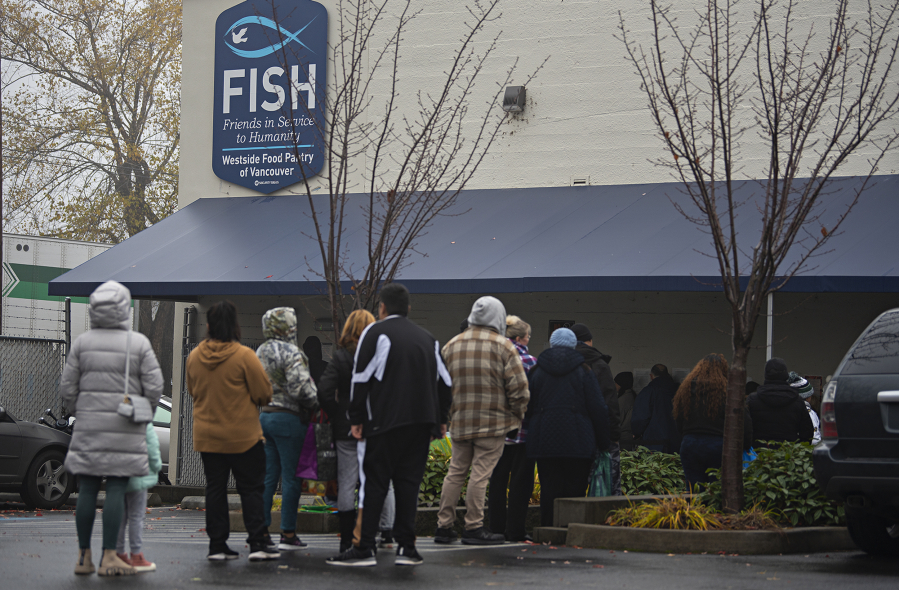 A line of people in need gather outside FISH of Vancouver as they prepare to grocery shop the day before Thanksgiving.