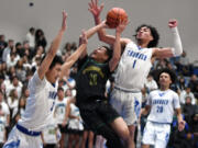Evergreen freshman Dez Daniel, center, shoots the ball under pressure from Mountain View senior Isaiah Vargas, right, and senior Peter Nguyen on Tuesday, Nov. 29, 2022, during the Thunder’s 74-60 win against Evergreen at Mountain View High School.