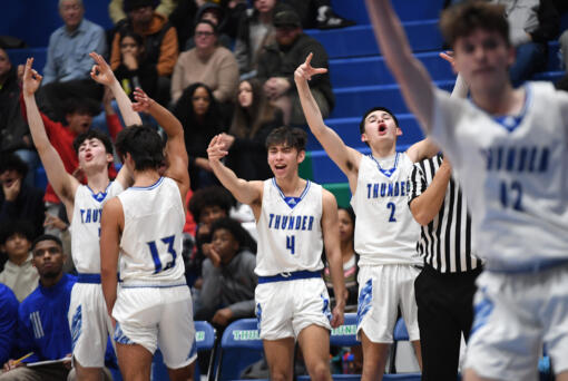 Mountain View players celebrate a basket Tuesday, Nov. 29, 2022, during the Thunder’s 74-60 win against Evergreen at Mountain View High School. (Taylor Balkom/The Columbian)