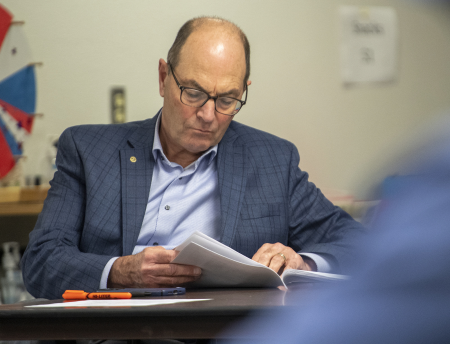 Clark County Auditor Greg Kimsey reviews documents during Tuesday's Canvassing Board meeting.