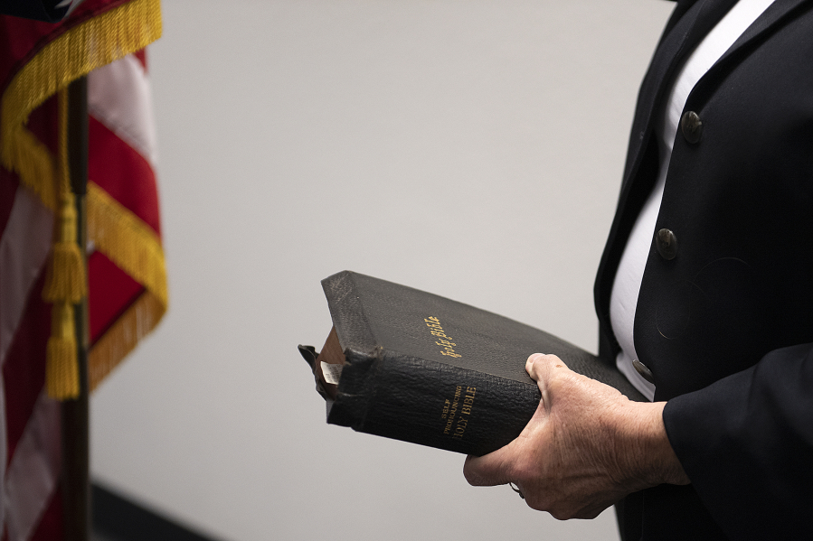 Sue Marshall, new District 5 Clark County Councilor, holds a copy of the Bible as she is sworn in at the Clark County Elections Office Wednesday afternoon.