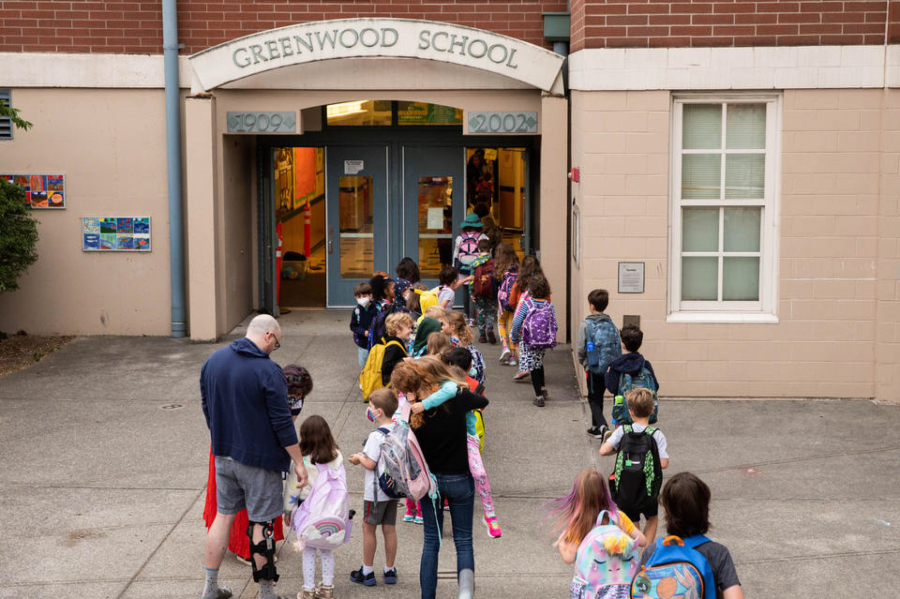 Students enter Greenwood Elementary on the first day of school on Wednesday, Sept. 14, 2022.