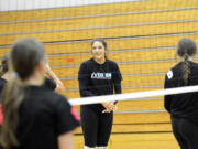 Elle Schoene chats with a teammate during a practice at La Center High School. Schoene and the La Center volleyball team have high goals heading into the Class 1A state volleyball tournament.