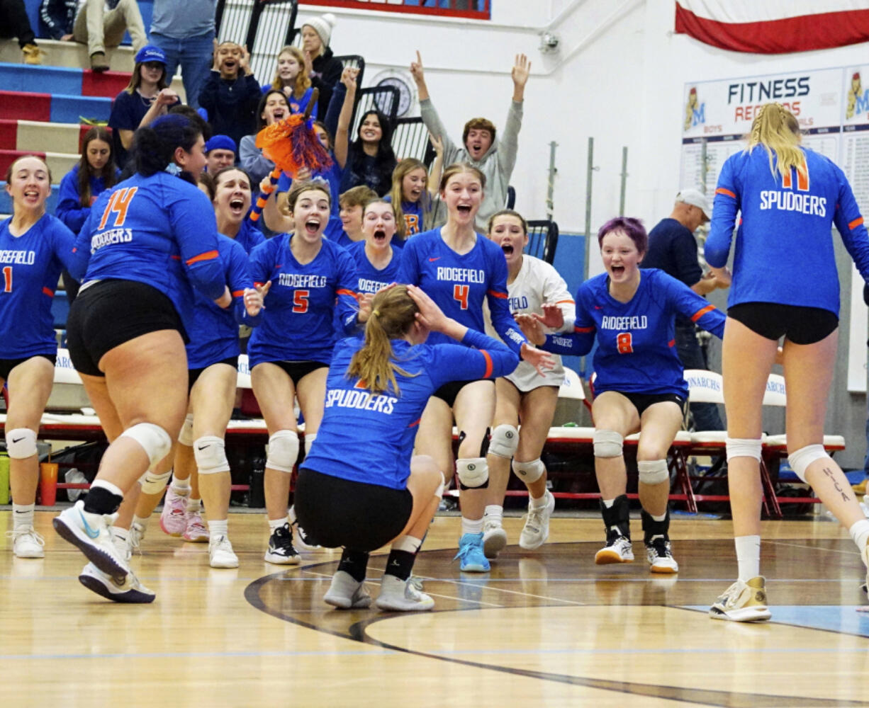 The Ridgefield Spudders celebrate match point, winning the 2A District 4 volleyball championship in five sets against rival Columbia River on Saturday, Nov. 12, 2022, at Mark Morris High School in Longview.