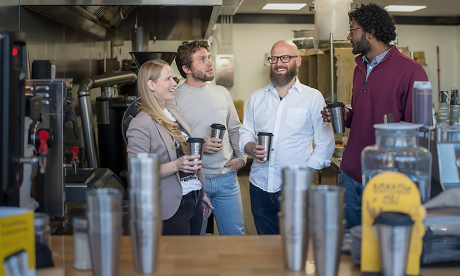 Forever Ware co-founder Natasha Gaffer, left, Chief Financial Officer Lee Sweatt and co-founders Nick Krumholz and Nolan Singroy gather at Roots Coffee where Singroy is a regular customer and the shop uses their mugs.
