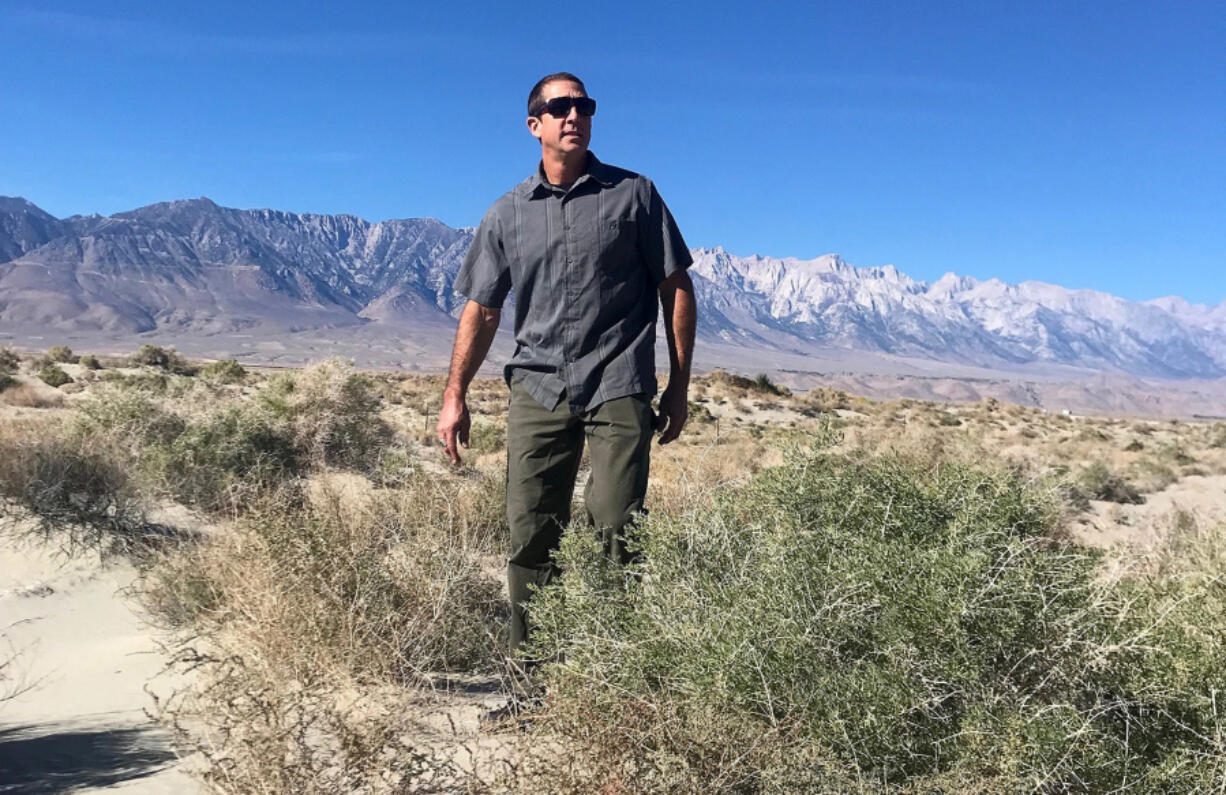 Great Basin Unified Air Pollution Control District's Phillip Kiddoo walks along the northern edge of dry Owens Lake.