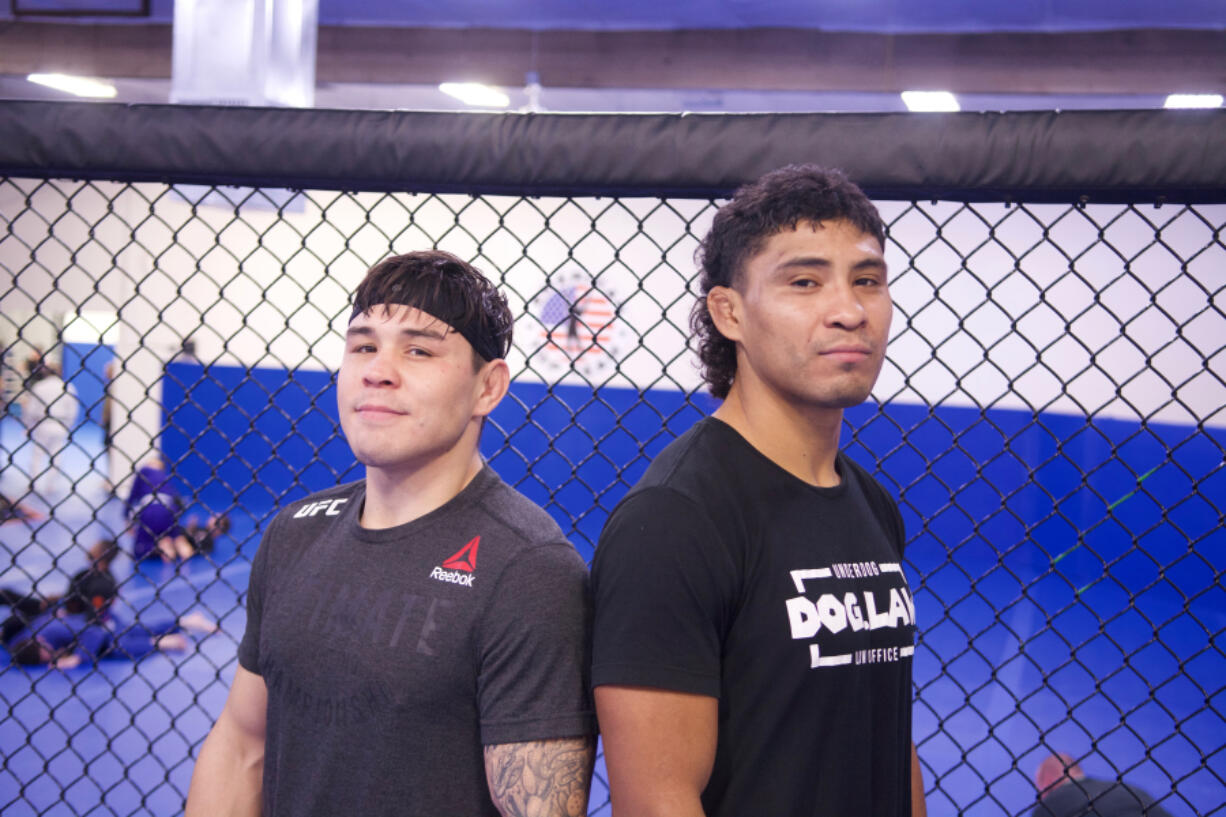Professional mixed martial arts fighters Ricky Simon, left, and John Simon pose at American Top Team in Portland. John Simon will headline an MMA event at the Clark County Fairgrounds on Nov. 19 with his cousin, UFC rising star Ricky Simon, in his corner.