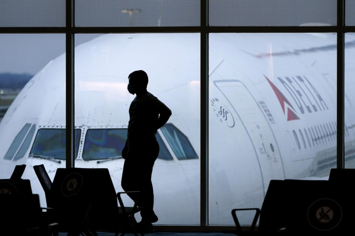 A passenger waits for a Delta Airlines flight at Hartsfield-Jackson International Airport in Atlanta on Feb. 18, 2021.