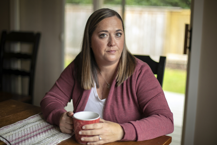 Marie Riley, 42, sits in her dining room with a cup of tea Tuesday, Oct. 25, 2022, at her family???s home in North Bend, Washington. Riley was born with tetralogy of fallot, a rare congenital heart condition that has required multiple open-heart surgeries during her lifetime.