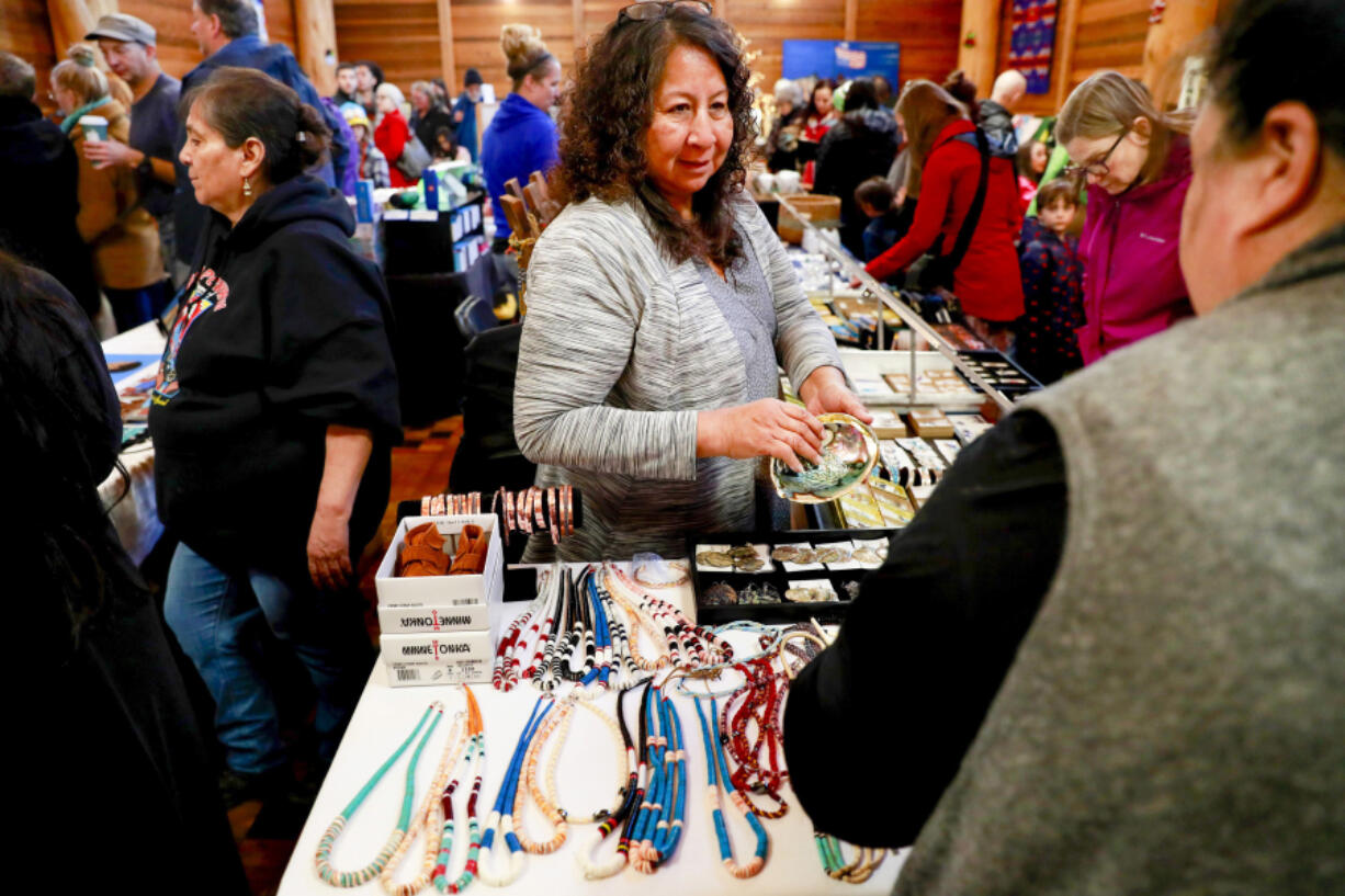 Theresa Jackson-Chun sells artwork during the 2019 Duwamish Longhouse and Cultural Center's annual holiday Native Art Market in West Seattle.