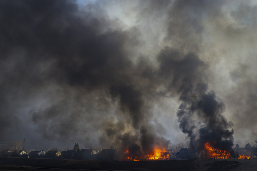 Two homes are consumed by wildfire in the Centennial Heights neighborhood on Dec. 30, 2021, in Louisville, Colo.
