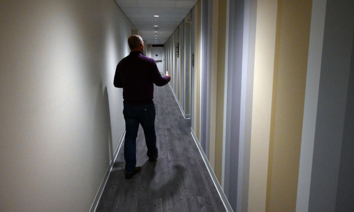 Tim O'Ferrall, general manager of Fort Meade Alliance, walks down a hallway that features colorful walls in the Education and Resiliency Center at Kuhn Hall at Fort George G. Meade.