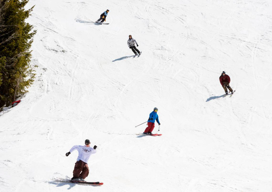People ski and snowboard on the last day of the season at Bogus Basin, Idaho, in April. The resort reopened on Nov. 19. (Sarah A.