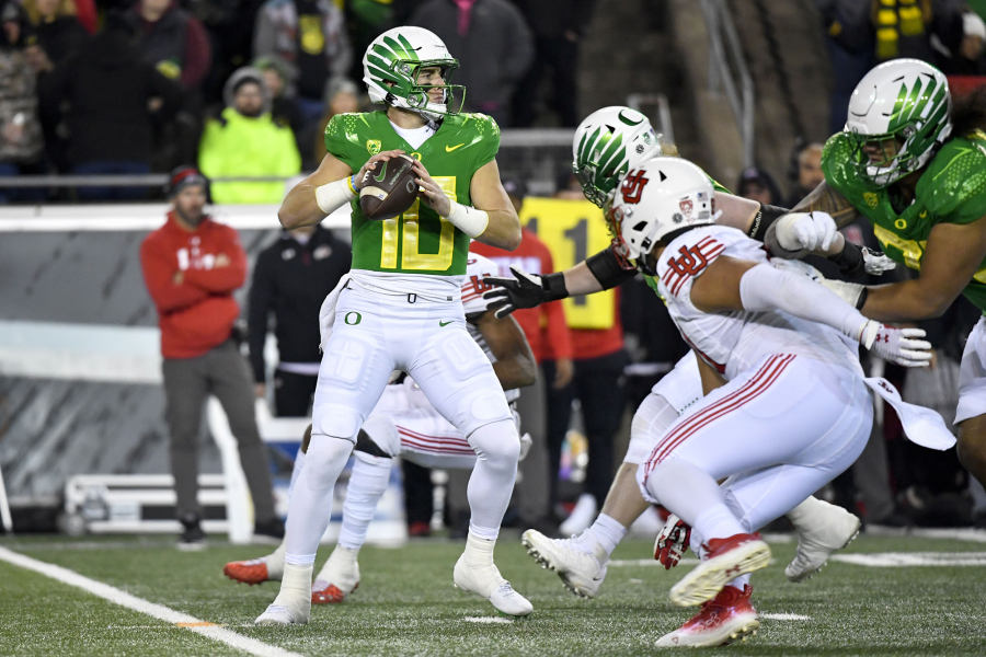 Oregon quarterback Bo Nix (10) looks to pass against Utah during the second half of an NCAA college football game Saturday, Nov. 19, 2022, in Eugene, Ore.