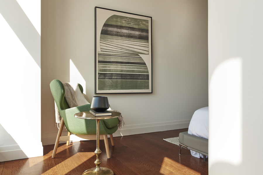 A green upholstery piece is paired with artwork to add an inspirational color moment.