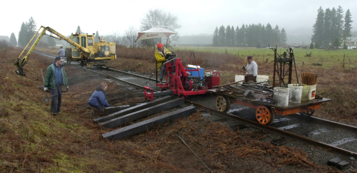 The Chelatchie Prairie Railroad is receiving $4.7 million from Washington transportation funds for the railroad's rehabilitation. In this 2002 photo, BYCX Railroad volunteers replace rotted ties on the north end of the line.