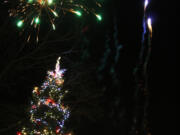 Fireworks light the sky above the just-lit Christmas tree in downtown Camas at the 2018 Hometown Holidays event.