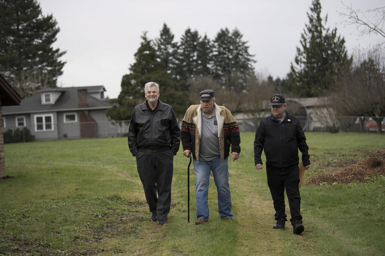 Veterans Ron Powers, from left, Ron Fryer and Mike Stacey walk on property for a proposed micro-home village for female veterans off Northeast St. James Road in December 2016.
