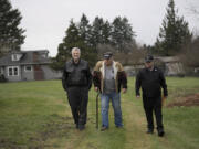 Veterans Ron Powers, from left, Ron Fryer and Mike Stacey walk on property for a proposed micro-home village for female veterans off Northeast St. James Road in December 2016.