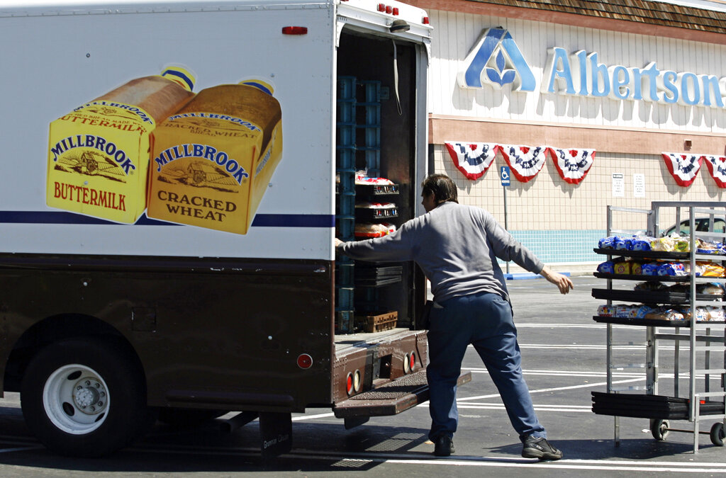 FILE - Mitch Maddox, a bread route salesman, loads bread Tuesday, May 30, 2006, outside the Eagle Rock Albertsons store in Los Angeles. Two of the nation’s largest grocers have agreed to merge in a deal that would help them better compete with Walmart, Amazon and other major companies that have stepped into the grocery business. Kroger on Friday, Oct. 14, 2022  bid $20 billion for Albertsons Companies Inc., or $34.10 per share.