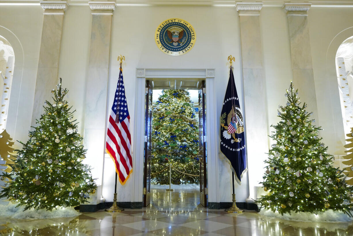 Cross Hall and the Blue Room of the White House are decorated for the holiday season during a press preview of holiday decorations at the White House, Monday, Nov. 28, 2022, in Washington.