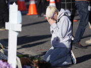 Dallas Dutka of Broomfield, Colo., prays by a makeshift memorial, Tuesday Nov. 22, 2022, for the victims of a mass shooting at a gay nightclub in Colorado Springs, Colo. Dutka's cousin, Daniel Aston, was killed in the shooting.