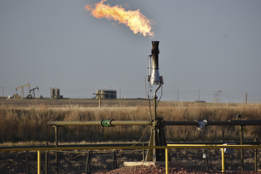 FILE - A flare for burning excess methane, or natural gas, from crude oil production, is seen at a well pad east of New Town, N.D., May 18, 2021. The Interior Department on Monday, Nov. 28, 2022, proposed rules to limit methane leaks from oil and gas drilling on public lands, the latest action by the Biden administration to crack down on emissions of methane, a potent greenhouse gas that contributes significantly to global warming.