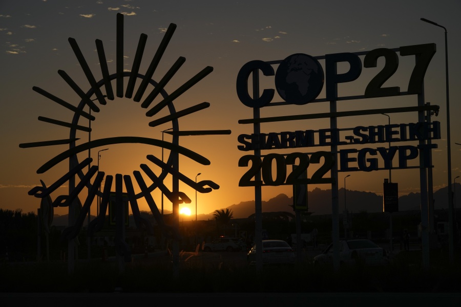 The sunsets behind the COP27 logo outside the venue of the COP27 U.N. Climate Summit, Saturday, Nov. 12, 2022, in Sharm el-Sheikh, Egypt.