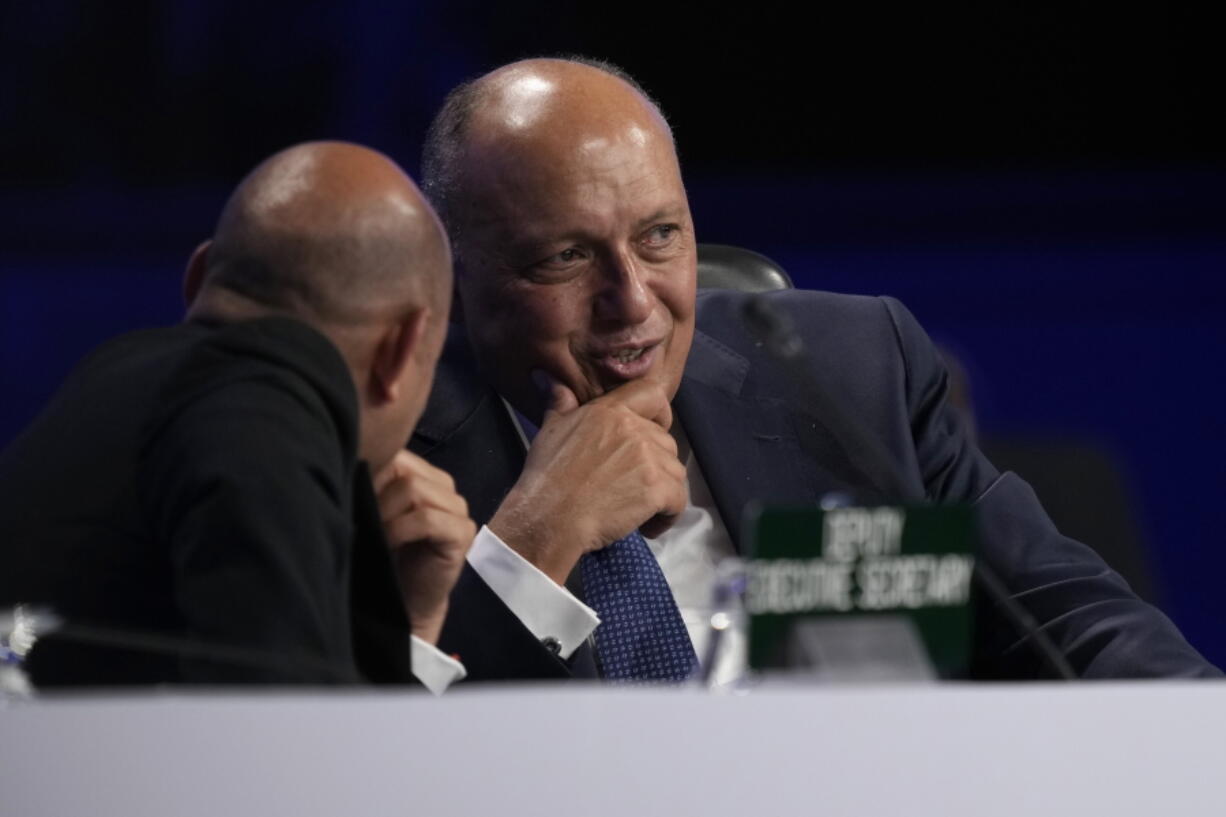 Sameh Shoukry, president of the COP27 climate summit, right, talks with Simon Stiell, U.N. climate chief, during a break in a closing plenary session at the U.N. Climate Summit, Sunday, Nov. 20, 2022, in Sharm el-Sheikh, Egypt.