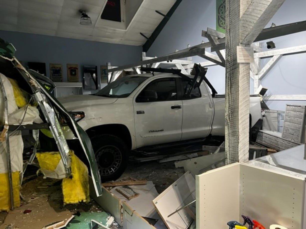 Two men were arrested early Thursday morning after deputies say they burglarized Orchards Cannabis Market by driving a stolen pickup inside the building.