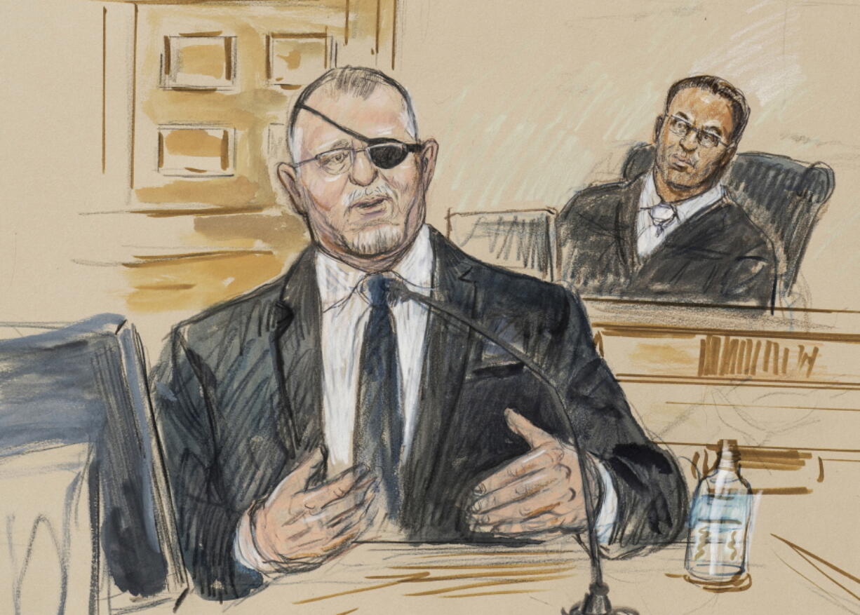 FILE - This artist sketch depicts the trial of Oath Keepers leader Stewart Rhodes, left, as he testifies before U.S. District Judge Amit Mehta on charges of seditious conspiracy in the Jan. 6, 2021, attack on the U.S. Capitol, in Washington, Nov. 7, 2022.  Jury deliberations are expected to begin soon.