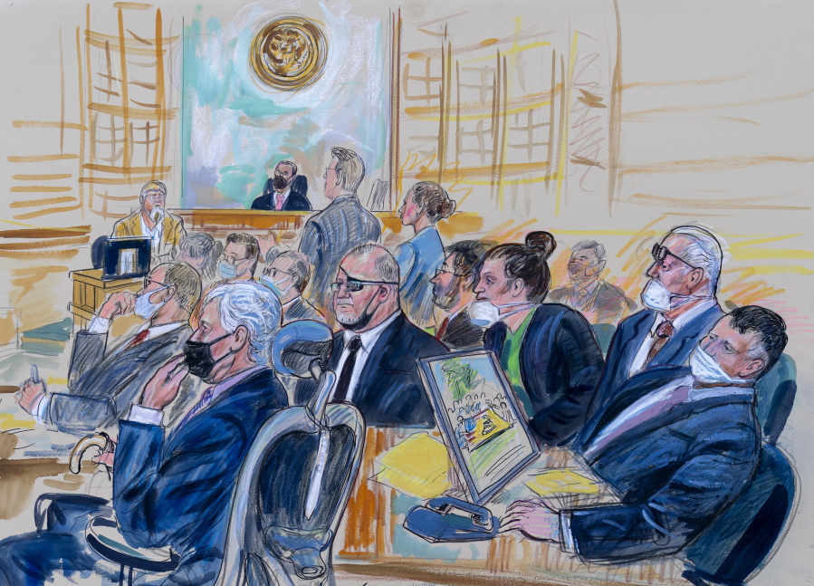 FILE - This artist sketch depicts the trial of Oath Keepers leader Stewart Rhodes and four others charged with seditious conspiracy in the Jan. 6, 2021, Capitol attack, in Washington, Oct. 6, 2022. Shown above are, witness John Zimmerman, who was part of the Oath Keepers' North Carolina Chapter, seated in the witness stand, defendant Thomas Caldwell, of Berryville, Va., seated front row left, Oath Keepers leader Stewart Rhodes, seated second left with an eye patch, defendant Jessica Watkins, of Woodstock, Ohio, seated third from right, Kelly Meggs, of Dunnellon, Fla., seated second from right, and defendant Kenneth Harrelson, of Titusville, Fla., seated at right. Assistant U.S. Attorney Kathryn Rakoczy is shown in blue standing at right before U.S. District Judge Amit Mehta. Watkins told jurors Wednesday, Nov.