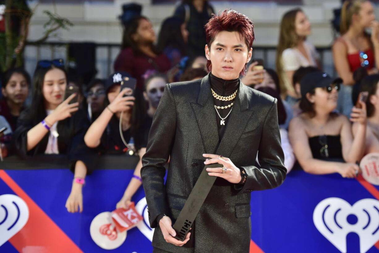 FILE - Singer Kris Wu celebrates his award for Fan Fave New Artist on the red carpet at the iHeartRadio MMVAs in Toronto on Aug. 26, 2018. A Beijing court on Friday, Nov. 25, 2022 sentenced Chinese-Canadian pop star Kris Wu to 13 years in prison on charges including rape.