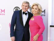 FILE - Todd Chrisley, left, and his wife, Julie Chrisley, pose for photos at the 52nd annual Academy of Country Music Awards on April 2, 2017, in Las Vegas. Todd and Julie Chrisley were driven by greed as they engaged in an extensive bank fraud scheme and then hid their wealth from tax authorities while flaunting their lavish lifestyle, federal prosecutors said, arguing the reality television stars should receive lengthy prison sentences. They were found guilty on federal charges in June and are set to be sentenced by U.S. District Judge Eleanor Ross in a hearing that begins Monday, Nov. 21.