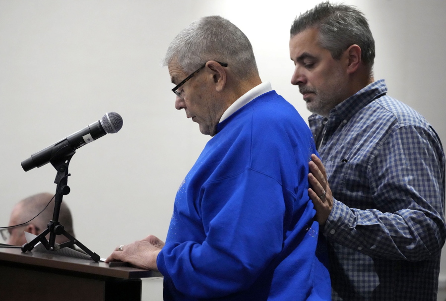 Dave Sorenson, left, the husband of Virginia "Ginny" Sorenson, gives a victim statement as his son Marshall stands by during Darrell Brooks' sentencing in a Waukesha County Circuit Court in Waukesha, Wis., on Tuesday, Nov. 15, 2022. Dozens of people are expected to speak at the sentencing proceedings for Brooks, who is convicted of killing six people and injuring dozens more when he drove his SUV through a Christmas parade in Waukesha last year.