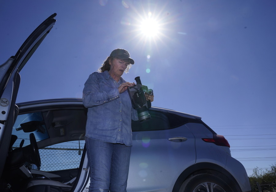 Sharon Wilson sets up a thermal imaging camera near a compressor station in Arlington, Texas, Tuesday, Oct. 18, 2022. Wilson, a field advocate for Earthworks, which promotes alternatives to fossil fuels, uses the high-tech camera to detect methane leaks at oil and gas facilities.