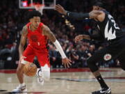 Portland Trail Blazers guard Anfernee Simons, left, drives against Los Angeles Clippers forward Robert Covington during the first half of an NBA basketball game in Portland, Ore., Tuesday, Nov. 29, 2022.
