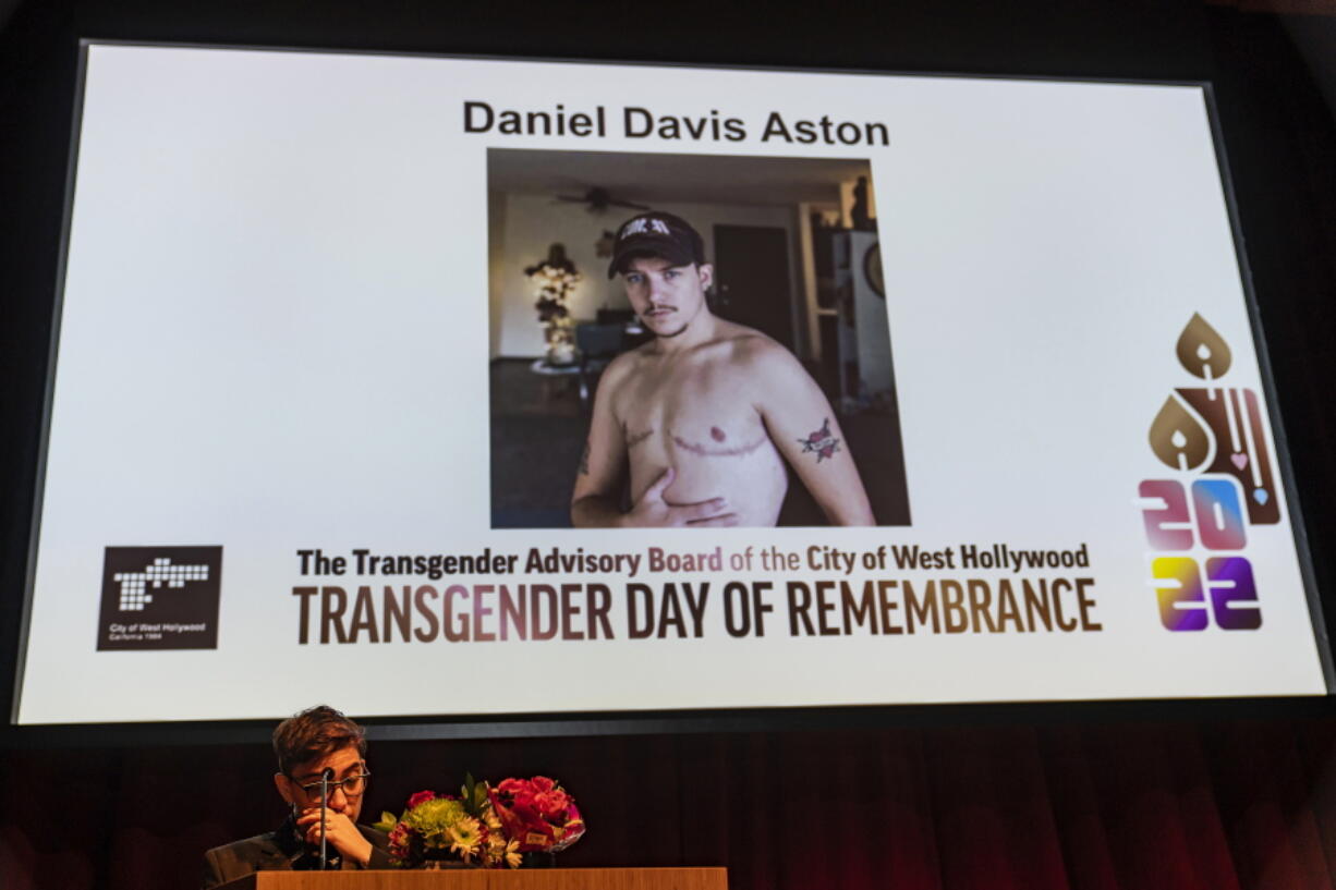 Musician Ryan Cassata reads the name of 28-year-old victim Daniel Davis Aston, a bartender killed at Club Q in Colorado Springs, Colo., at the Transgender Day of Remembrance event in West Hollywood, Calif., Sunday night, Nov. 20, 2022.