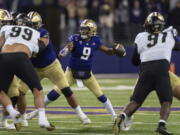 Washington quarterback Michael Penix Jr. prepares to throw a pass during the first half of the team's NCAA college football game against Colorado, Saturday, Nov. 19, 2022, in Seattle.