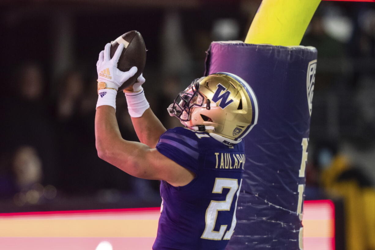 Washington running back Wayne Taulapapa celebrates after scoring a touchdown against Colorado during the first half of an NCAA college football game Saturday, Nov. 19, 2022, in Seattle.