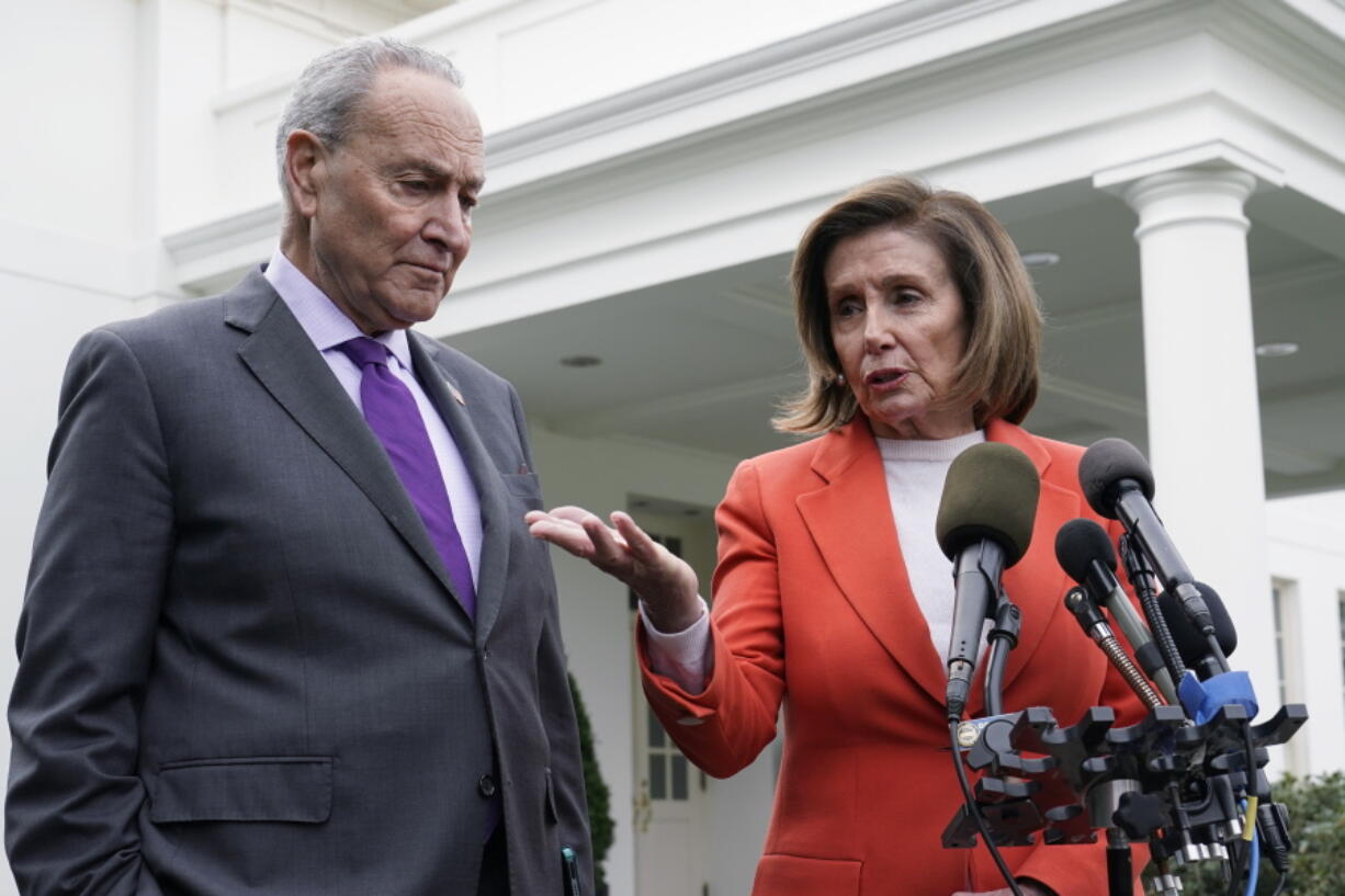 FILE - Senate Majority Leader Chuck Schumer of N.Y., right, listens as House Speaker Nancy Pelosi of Calif., left, speaks to reporters at the White House in Washington, Nov. 29, 2022, about their meeting with President Joe Biden. Congress is moving swiftly to prevent a looming U.S. rail workers strike.