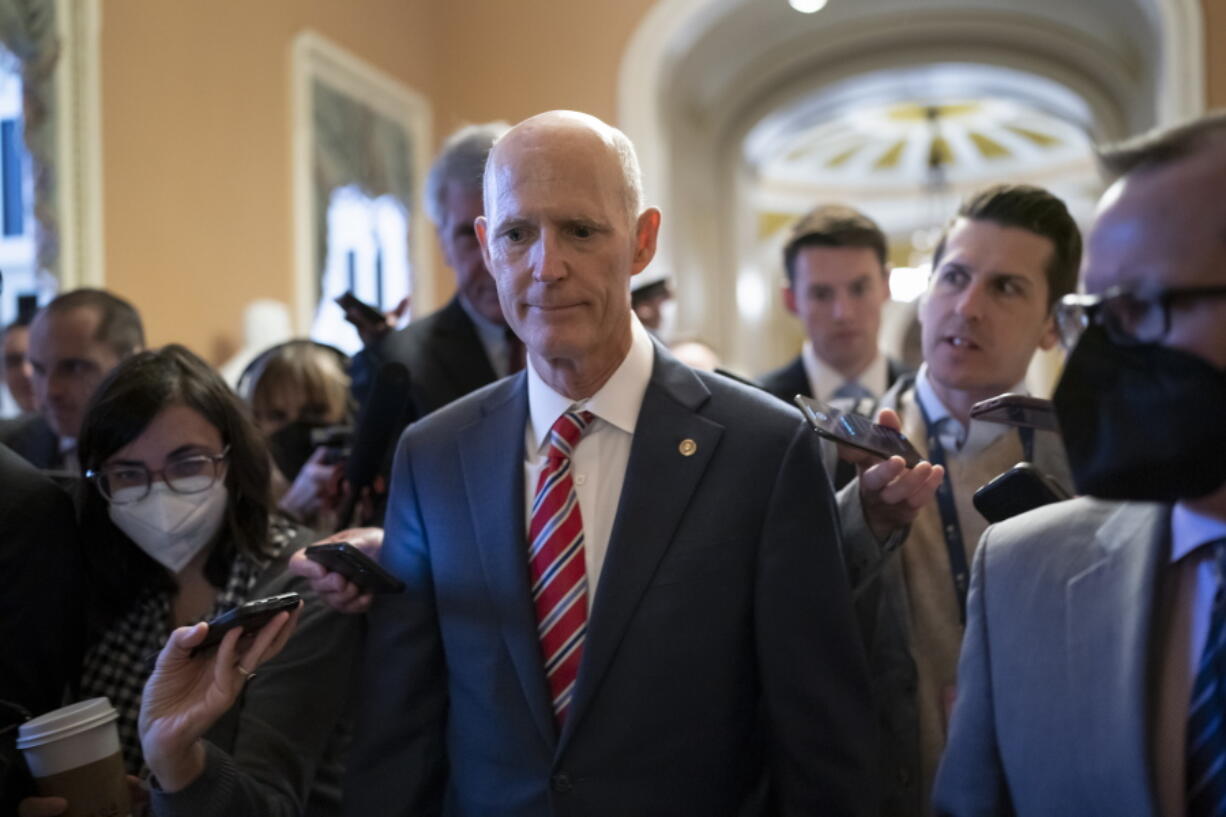 Sen. Rick Scott, R-Fla., who led the Senate Republican campaign arm this year, is surrounded by reporters as he arrives at the historic Old Senate Chamber where he is mounting a long-shot bid to unseat Senate Republican leader Mitch McConnell, at the Capitol in Washington, Wednesday, Nov. 16, 2022. (AP Photo/J.