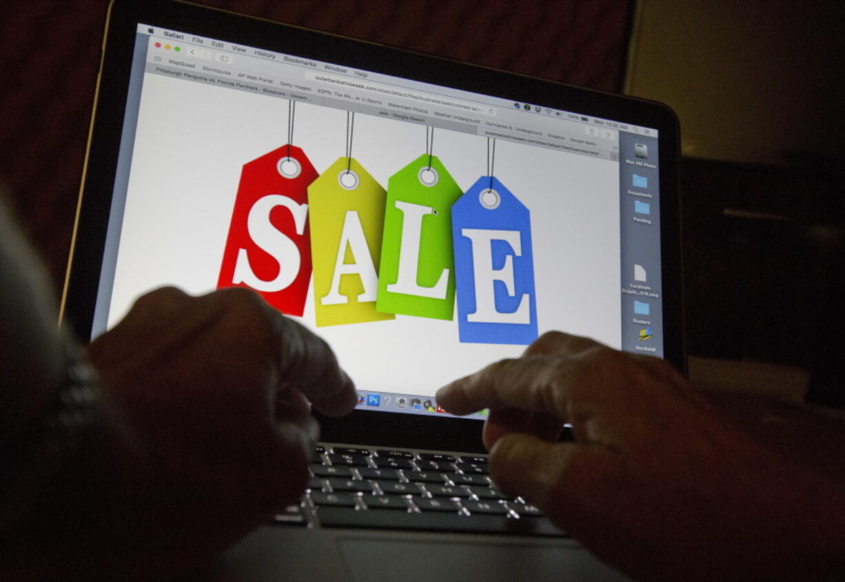 In this Dec. 12, 2016, photo, a person searches the internet for sales, in Miami. Days after flocking to stores on Black Friday, consumers are turning online for Cyber Monday to score more discounts on gifts and other items that have ballooned in price because of high inflation. Adobe Analytics, which tracks transactions for top online retailers, forecasts Cyber Monday will remain the year's biggest online shopping day and rake in up to $11.6 billion in sales.