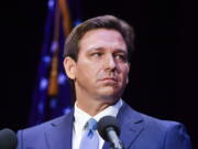 FILE '?? Florida's Republican Gov. Ron DeSantis takes to the stage to debate his Democratic opponent Charlie Crist in Fort Pierce, Fla., on Oct. 24, 2022. Both DeSantis a Republican and California Gov. Gavin Newsom, a Democrat said their reelection victories were in part because of their commitment to freedom. But the governors have vastly different definitions of what freedom means.