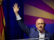 Sen. Mark Kelly, D-Ariz., waves supporters goodnight during an election night event in Tucson, Ariz., Tuesday, Nov. 8, 2022.