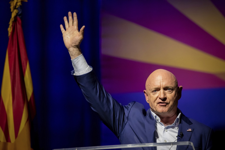Sen. Mark Kelly, D-Ariz., waves supporters goodnight during an election night event in Tucson, Ariz., Tuesday, Nov. 8, 2022.