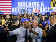 President Joe Biden poses for photos with Maryland Democratic gubernatorial candidate Wes Moore during a campaign rally at Bowie State University in Bowie, Md., Monday, Nov. 7, 2022.