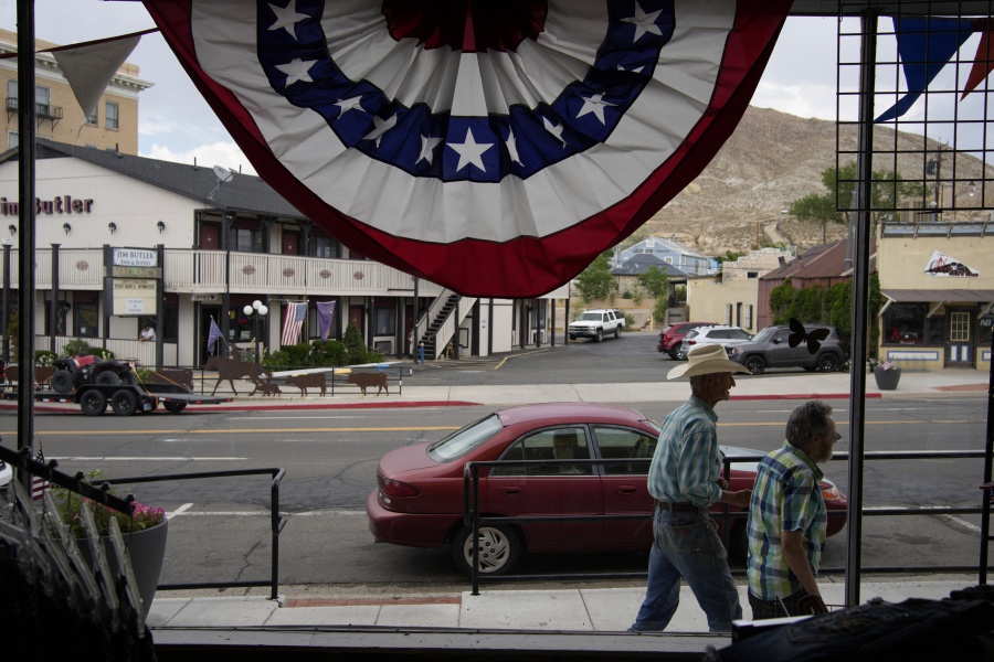 FILE - People walk along the main drag in the county seat of Nye County on July 18, 2022, in Tonopah, Nev. The American Civil Liberties Union of Nevada asked the state's secretary of state Wednesday, Nov. 2 to formally investigate allegations of partisan improprieties in a hand-count of advance election ballots that's currently on hold in rural Nye County after a state Supreme Court ruling raised questions about the legality of the process last week.