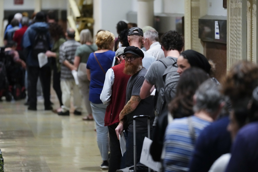Voters wait in line to make a correction to their ballots for the midterm elections at City Hall in Philadelphia, Monday, Nov. 7, 2022.